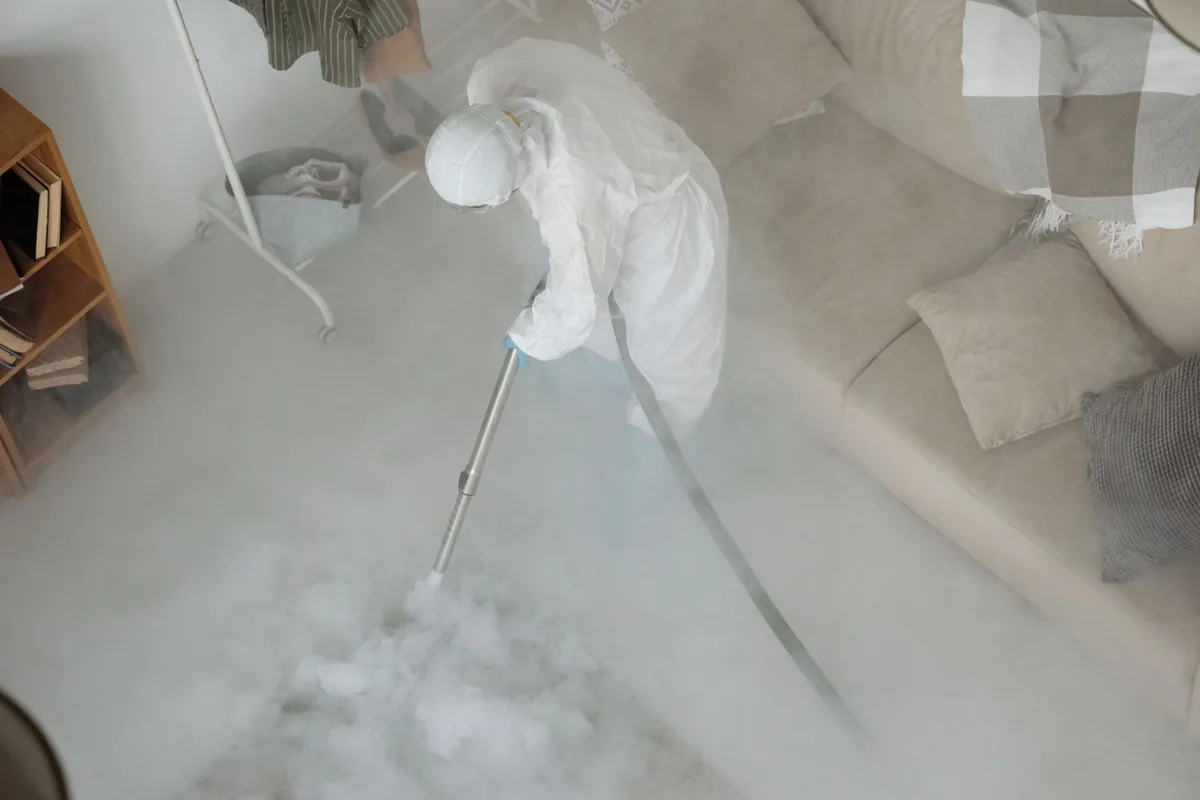 Biohazard cleanup technician in protective equipment, Oakville, MO